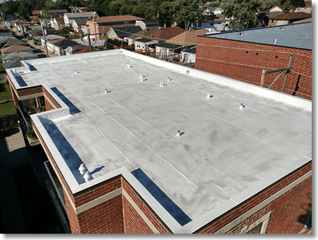 A building with a white roof and a brick wall.