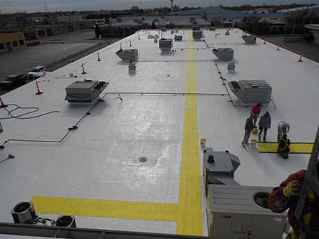 A large white building with yellow lines on the roof.